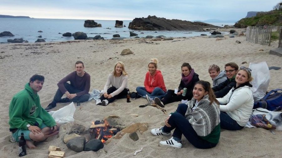 Emilie Roussis sits on the beach with a circle of friends, near Corrymeela, Northern Ireland.