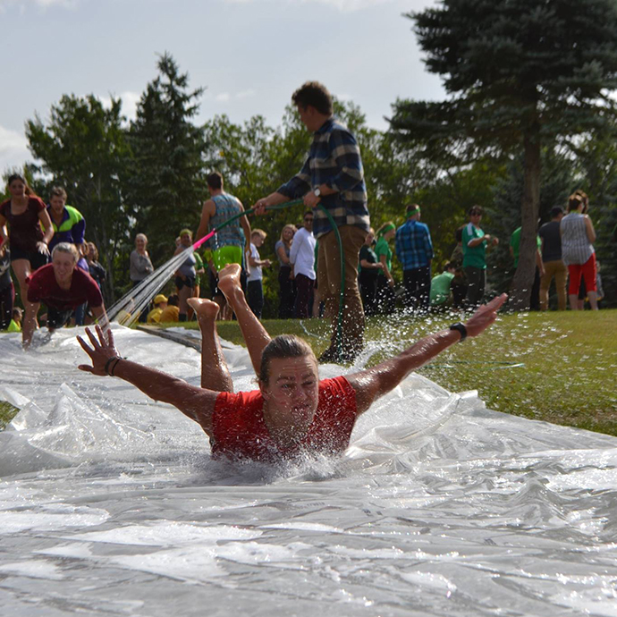 Nicole Ternowsky - A student slides down a slip and slide during CMU's GO Olympics!